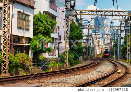 Odakyu Line Romancecar GSE Express running through a residential area Odakyu Line Romancecar GSE Express running through a residential area 118997518