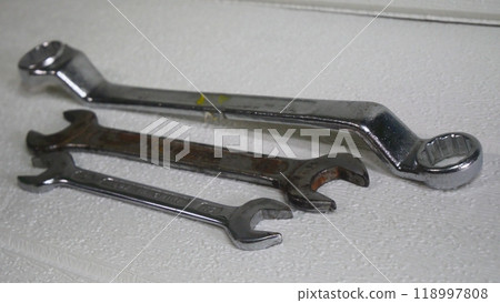 Various wrenches placed on a white wooden floor Various wrenches placed on a white wooden floor 118997808