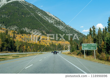 Driving on Trans-Canada Highway (Highway 1) in a autumn sunny day. Banff National Park, Canadian Rockies. Alberta, Canada. Driving on Trans-Canada Highway (Highway 1) in a autumn sunny day. Banff National Park, Canadian Rockies. Alberta, Canada. 118998896