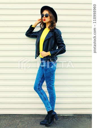 Fashionable stylish young woman model full length posing in black jacket, hat on white background Fashionable stylish young woman model full length posing in black jacket, hat on white background 118998960