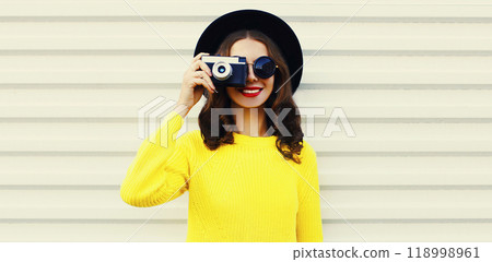Portrait of happy smiling young woman photographer with film camera on white background Portrait of happy smiling young woman photographer with film camera on white background 118998961