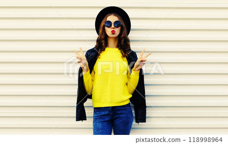 Fashionable stylish young woman posing in black jacket with backpack on white background 118998964