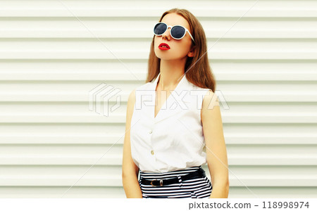 Portrait of beautiful young woman model posing wearing sunglasses on white background 118998974