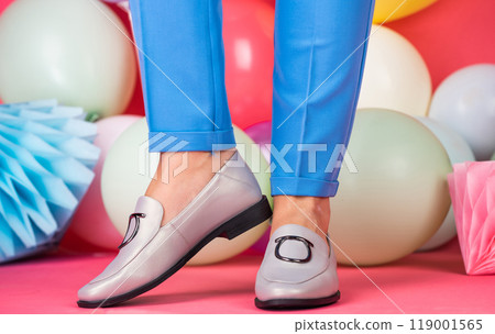 female feet in comfortable shoes loafers at colorful balloons, black friday female feet in comfortable shoes loafers at colorful balloons, black friday 119001565
