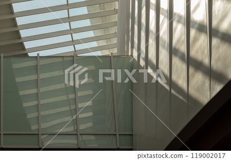 Modern architecture interior design of metal structure building with Burred light and shadow passing through glazed ceiling. 119002017
