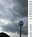 Dark clouds and clock 119002264