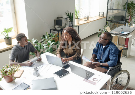 High angle shot of African American office workers having business meeting in modern office 119002626