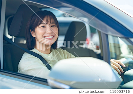 A woman driving a car A woman going for a drive A woman driving a car A woman going for a drive 119003716