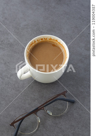 Image of a person relaxing while drinking a cafe latte, a mixture of espresso and milk 119004387