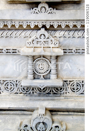 A white marble sculpture of a Hindu saint in the temple. Oldest temple in India. Beautiful sculpture of ancient India 13th century. Wall mounting background. Wall poster.  119006528