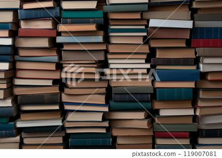 Rows of tightly packed hardcover books with various colored spines, stacked in a vertical arrangement 119007081