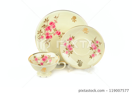 Vintage porcelain cup and saucer isolated on white. Vintage porcelain cup and saucer isolated on white. 119007577