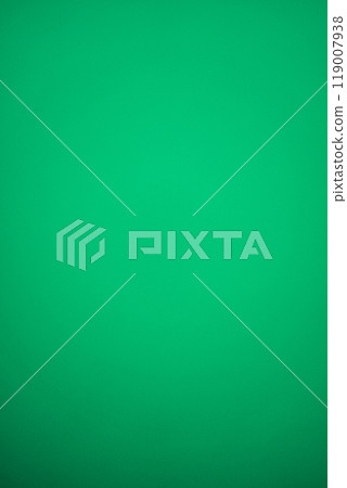 Vertical plain green background with a slight gradient and metallic shiny effect, darkening downwards. Blank backdrop for graphic design with copy space for Christmas, New Year or Greenery Day. 119007938