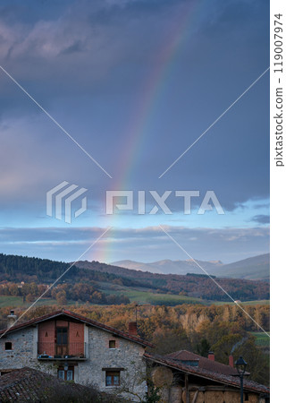 Rainbow over a rustic countryside house and hills Rainbow over a rustic countryside house and hills 119007974