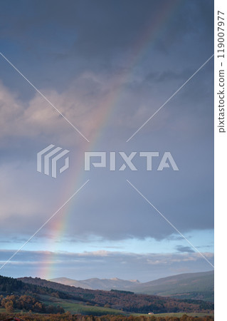 Rainbow over mountain landscape at dusk 119007977