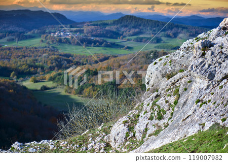 Rocky hillside with panoramic view of rolling hills and autumn forests Rocky hillside with panoramic view of rolling hills and autumn forests 119007982