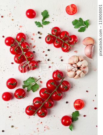 branch with mini cherry tomatoes, with spices and herbs, garlic, food background, top view, on a white background, 119008001