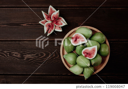 Fresh green figs, top view, on a wooden table, 119008047