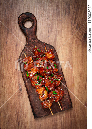 yakitori chicken kebab, on skewers, with green onions and sesame seeds, top view, without people, yakitori chicken kebab, on skewers, with green onions and sesame seeds, top view, without people, 119008065