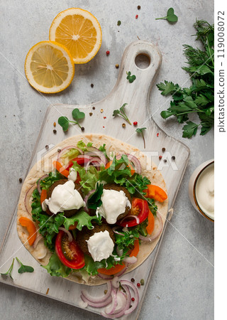 Tortilla with falafel and vegetable salad, white sauce, Arabic cuisine, top view, homemade, no people, vegetarian food, Tortilla with falafel and vegetable salad, white sauce, Arabic cuisine, top view, homemade, no people, vegetarian food, 119008072