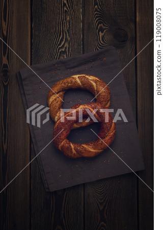 Traditional Turkish bagel Simit, Top view on a wooden table, vertical, no people, rustic style, Traditional Turkish bagel Simit, Top view on a wooden table, vertical, no people, rustic style, 119008075