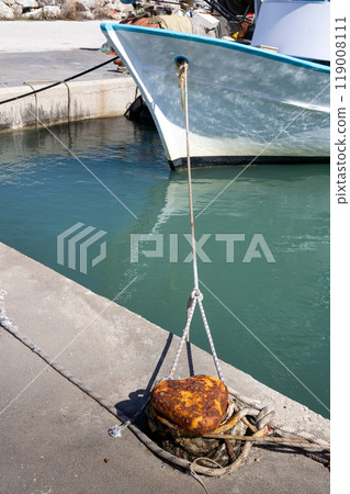 Rusted bollard and a boat, Astrakeri, Corfu, Greece Rusted bollard and a boat, Astrakeri, Corfu, Greece 119008111