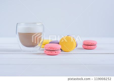Sweet delicious colorful macarons and cup of coffee. Sweet delicious colorful macarons and cup of coffee. 119008252