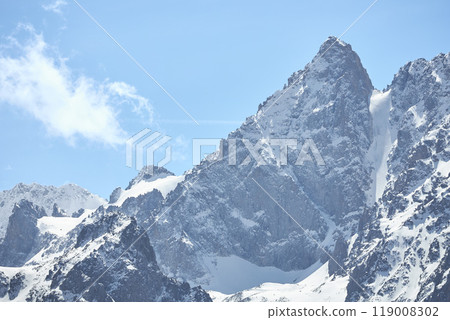 March in highlands. Snow mountain landscape background, blue sky, rocky cliff. Wild nature. Hight mountains trekking March in highlands. Snow mountain landscape background, blue sky, rocky cliff. Wild nature. Hight mountains trekking 119008302