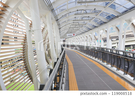 Pedestrian pathway or corridor or hallway between train station and other building. Pedestrian pathway or corridor or hallway between train station and other building. 119008518