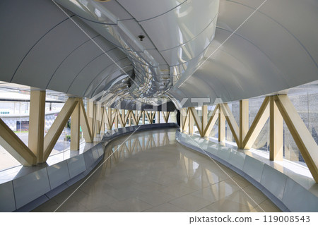 Modern pedestrian pathway or corridor or hallway between train station and other building. 119008543