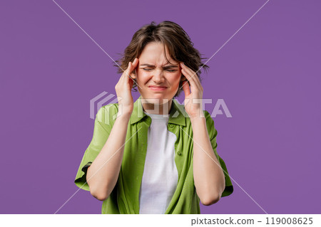 Portrait of beautiful suffering woman having headache, violet studio portrait. Girl putting hands on head. Concept of migraine problems, medicine, illness, magnetic storms concept. Portrait of beautiful suffering woman having headache, violet studio portrait. Girl putting hands on head. Concept of migraine problems, medicine, illness, magnetic storms concept. 119008625