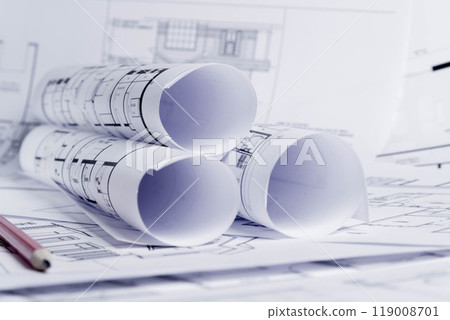 Construction plan. Scheme drawing rolled up in a roll. Home renovation planning. Construction plan. Scheme drawing rolled up in a roll. Home renovation planning. 119008701