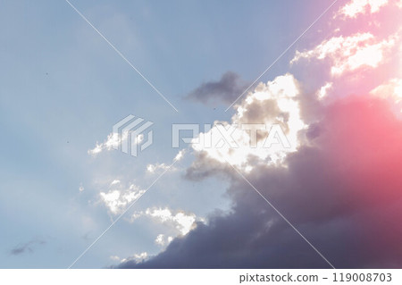 White clouds in bright sunlight. Revival of day. Clouds in glare of sun. White clouds in bright sunlight. Revival of day. Clouds in glare of sun. 119008703