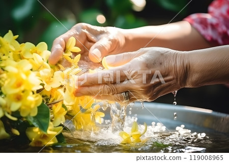 Hands performing ritual washing with water and flowers, Ganesh Visarjan ceremony Hands performing ritual washing with water and flowers, Ganesh Visarjan ceremony 119008965