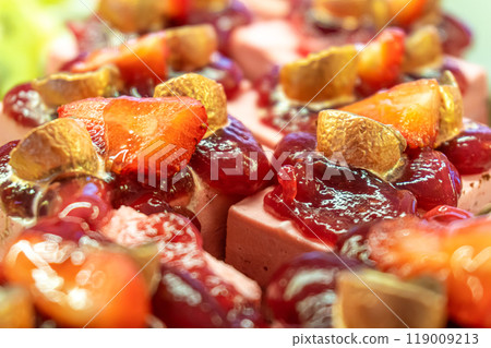 Fruit mousse pastries with berry jelly and fresh strawberries 119009213