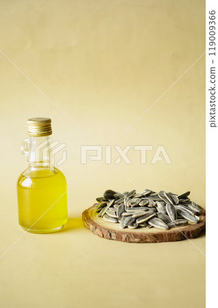 sunflower oil seed and oil in a container on table  119009366