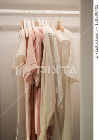 Stylish Minimalist Clothing Rack Displaying Soft, Trendy Pastel Apparel for a Chic Look Stylish Minimalist Clothing Rack Displaying Soft, Trendy Pastel Apparel for a Chic Look 119009402