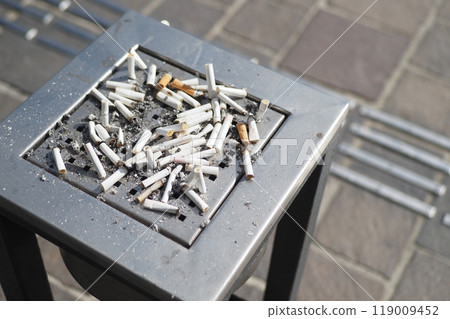 The collection of cigarette butts found in the outdoor ashtray on a public street The collection of cigarette butts found in the outdoor ashtray on a public street 119009452