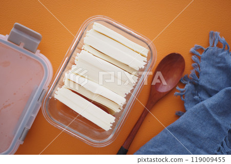 Slicing cheese into pieces closeup,  119009455