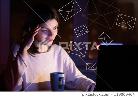 Girl sends emails, messages, works on a laptop at night. Girl sends emails, messages, works on a laptop at night. 119009464
