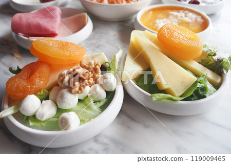 A Vibrant and Colorful Fresh Salad Comprising Fruits and Cheese Served in Decorative Bowls 119009465