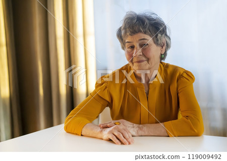 Old retired gray-haired woman in yellow blouse. Old retired gray-haired woman in yellow blouse. 119009492
