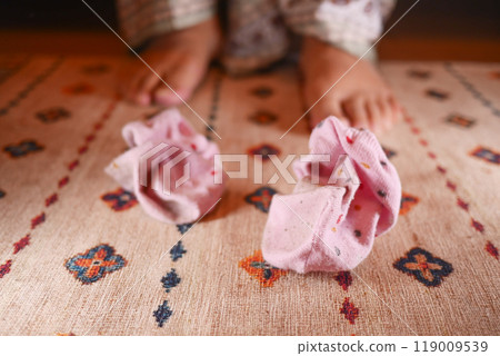 A Childs Joyful Playtime while Wearing Colorful and Vibrant Socks on a Cozy and Comfy Rug 119009539