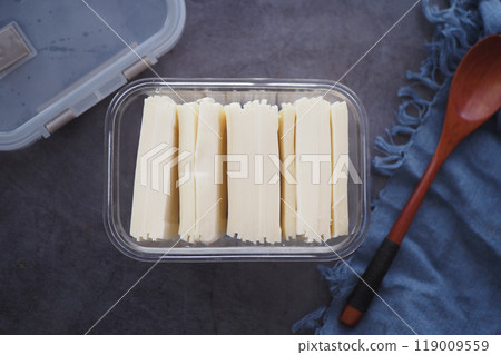 Slicing cheese into pieces closeup,  119009559
