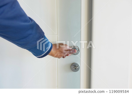 Man's Hand Opening door close up  119009584