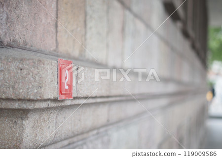house number. Decorative lettering on a brick wall. 119009586