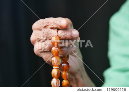 Close up of senior women hand praying at ramadan Close up of senior women hand praying at ramadan 119009656