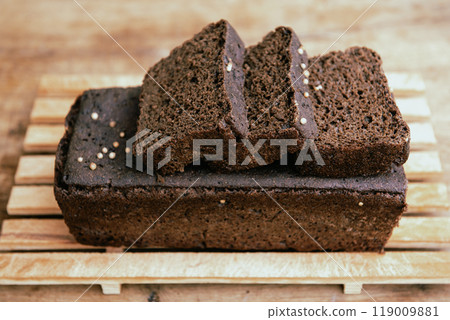 Sliced rye homemade bread. rye sourdough bread on a wooden cutting board. 119009881