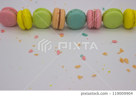 Assorted Macarons in a Line with Colorful Crumbs Assorted Macarons in a Line with Colorful Crumbs 119009904