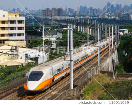 Taiwan High Speed Rail (THSR) curves around a curve with the cityscape in the background 119011029